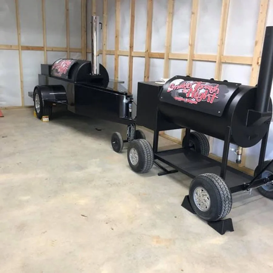 Black Jambo Backyard smoker with firewood on the lower rack