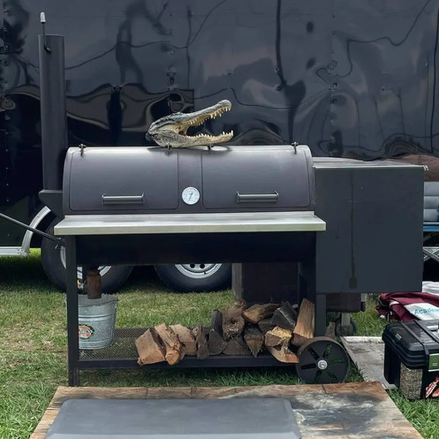 Jambo Backyard smoker with both doors open, stainless shelf and custom wheels
