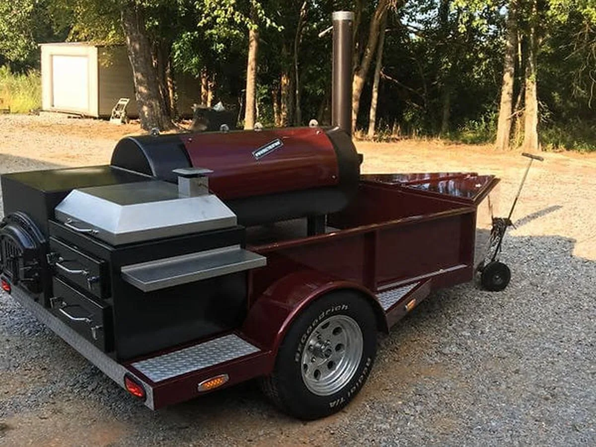 Burgundy Jambo J5 trailer with firebox, warmer and side boxes, rear three-quarter