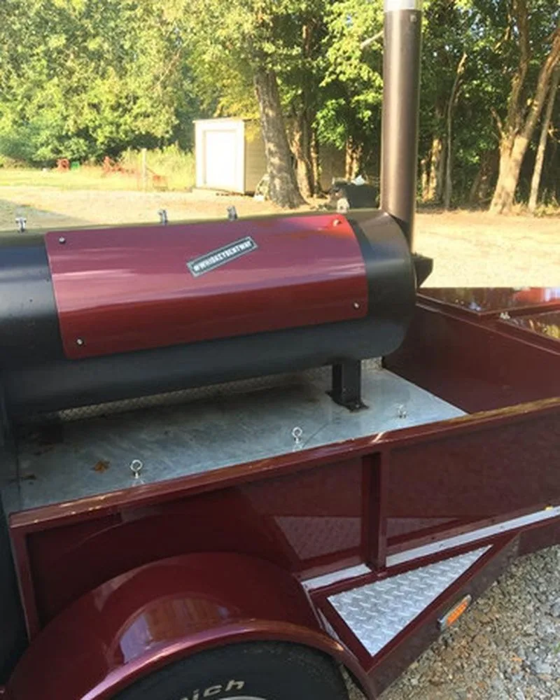 Burgundy Jambo J5 cook chamber on its trailer, close side view